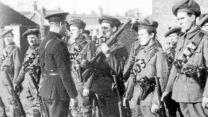 A black-and-white photo of an officer inspecting a line of Black and Tans.